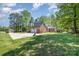 Spacious exterior featuring a long driveway, garage, and backyard deck at 127 Fantasy Ln, Mooresville, NC 28117