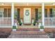 Inviting front porch decorated with colorful potted plants and a welcoming wreath, offering a charming entrance at 127 Fantasy Ln, Mooresville, NC 28117