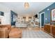 Open-concept living room features hardwood floors, a comfortable sectional sofa, and a stylish fireplace, ideal for relaxation at 127 Fantasy Ln, Mooresville, NC 28117