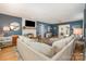 Cozy living room featuring a modern fireplace, stylish decor, plush sectional sofa, and plenty of natural light at 127 Fantasy Ln, Mooresville, NC 28117