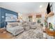 Bright and airy living room with hardwood floors, a cozy sectional sofa, and a charming fireplace, perfect for gatherings at 127 Fantasy Ln, Mooresville, NC 28117