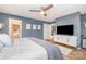 Bright main bedroom with a ceiling fan, TV, and view into the bathroom at 127 Fantasy Ln, Mooresville, NC 28117
