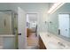 Bathroom featuring double sinks with an open door leading to the Primary bedroom at 13228 Crooked Pine Ct, Charlotte, NC 28215