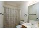 Cozy bathroom featuring a decorative shower curtain, toilet, and sink at 13228 Crooked Pine Ct, Charlotte, NC 28215