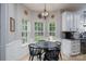 Bright breakfast nook with a three-window view, black table and chairs, and modern lighting at 13228 Crooked Pine Ct, Charlotte, NC 28215