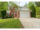 Charming two-story home with a brick and siding exterior, a red door, and well-manicured lawn at 13228 Crooked Pine Ct, Charlotte, NC 28215