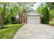 Charming brick home with red shutters, arched window, two-car garage, and a well-manicured lawn at 13228 Crooked Pine Ct, Charlotte, NC 28215