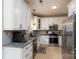 Well-lit kitchen features granite counters, stainless steel appliances, and white cabinets at 13228 Crooked Pine Ct, Charlotte, NC 28215