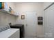 Functional laundry area with shelving, washer, dryer, and access to extra storage at 13228 Crooked Pine Ct, Charlotte, NC 28215