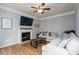 Cozy living room with fireplace, laminate wood floors, and comfortable seating at 13228 Crooked Pine Ct, Charlotte, NC 28215