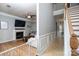 Spacious living room features fireplace, tv, ceiling fan, and seamless access to the hallway at 13228 Crooked Pine Ct, Charlotte, NC 28215