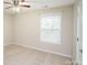 This bedroom features a ceiling fan, carpet flooring, and natural light at 1333 Rainier Dr, Fort Mill, SC 29708