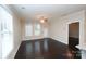 Bright living room features hardwood floors, a ceiling fan, and multiple windows that let in natural light at 1333 Rainier Dr, Fort Mill, SC 29708