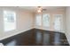 Bright living room features hardwood floors, a ceiling fan, and multiple windows that let in natural light at 1333 Rainier Dr, Fort Mill, SC 29708