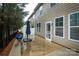 Back patio area, perfect for outdoor grilling or relaxing, with lush greenery, adjacent to the home's exterior at 1333 Rainier Dr, Fort Mill, SC 29708