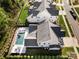 Aerial view of the home showcases a well-maintained yard, lush landscaping, and a sparkling in-ground pool at 14013 Pinoli Pine Cir, Huntersville, NC 28078