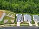 Stunning aerial view of a modern home with a private pool and lush green landscaping near a wooded area at 14013 Pinoli Pine Cir, Huntersville, NC 28078