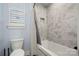 Bathroom with a white tub and shower featuring hexagon tile surround at 14013 Pinoli Pine Cir, Huntersville, NC 28078