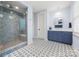 Elegant bathroom featuring tiled shower, patterned floor, and dual sink vanity at 14013 Pinoli Pine Cir, Huntersville, NC 28078