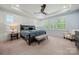 Spacious bedroom with natural light, tray ceilings, and a ceiling fan at 14013 Pinoli Pine Cir, Huntersville, NC 28078