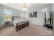 Charming bedroom with a patterned duvet, neutral carpet and complemented by a modern, decorative light fixture at 14013 Pinoli Pine Cir, Huntersville, NC 28078