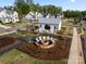 Overhead view of community fire pit and patio area near neighborhood homes at 14013 Pinoli Pine Cir, Huntersville, NC 28078