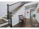 Entryway features hardwood flooring, a staircase with dark wood banister and a wooden bench seat at 14013 Pinoli Pine Cir, Huntersville, NC 28078