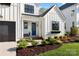 Close-up of front door with blue accent, tidy landscaping, and inviting front porch at 14013 Pinoli Pine Cir, Huntersville, NC 28078