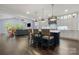 Open-concept kitchen with large island, pendant lighting, and views of the living area at 14013 Pinoli Pine Cir, Huntersville, NC 28078