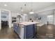 Beautiful kitchen island featuring sink, pendant lighting, and stainless steel dishwasher at 14013 Pinoli Pine Cir, Huntersville, NC 28078