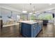 Open kitchen with a large center island, pendant lighting, and seamless flow to the dining area at 14013 Pinoli Pine Cir, Huntersville, NC 28078