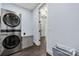 Laundry room with stacked washer and dryer, gray storage cabinet and light blue walls at 14013 Pinoli Pine Cir, Huntersville, NC 28078