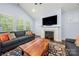 Comfortable living room featuring fireplace, natural light, and stylish furnishings at 14013 Pinoli Pine Cir, Huntersville, NC 28078