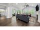 Bright living room with sliding glass doors to covered porch, hardwood floors, and fireplace at 14013 Pinoli Pine Cir, Huntersville, NC 28078