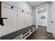 Mudroom featuring built-in storage cubbies, a bench, hooks, and dark hardwood flooring at 14013 Pinoli Pine Cir, Huntersville, NC 28078