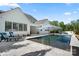View of the pool with lounge chairs and umbrellas, perfect for relaxing and enjoying the outdoors at 14013 Pinoli Pine Cir, Huntersville, NC 28078