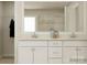 Bathroom featuring a walk-in closet, double vanity, and a large mirror at 1512 Croydon St, Indian Land, SC 29707