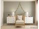 Charming Bedroom with a golden crib, two dressers with lamps, and decorative star garland at 1512 Croydon St, Indian Land, SC 29707