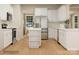 Modern kitchen with white cabinets, stainless steel appliances, and a stylish island at 1512 Croydon St, Indian Land, SC 29707