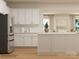 This kitchen features white cabinets, stainless steel appliances, and an island with a light countertop at 1512 Croydon St, Indian Land, SC 29707