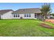 Well maintained backyard with green grass, view of the screened porch, and manicured landscaping at 1541 Croydon St, Indian Land, SC 29707