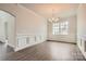 Formal dining room featuring hardwood floors, modern wainscoting, a modern chandelier, and a large window at 1541 Croydon St, Indian Land, SC 29707