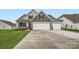 Charming home featuring a three car garage, stone accents, landscaping, and a well-manicured lawn at 1541 Croydon St, Indian Land, SC 29707