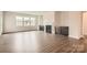 Spacious living room with hardwood floors, a cozy fireplace, custom cabinetry, and lots of natural light at 1541 Croydon St, Indian Land, SC 29707