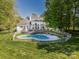 Aerial view of the home with a swimming pool and large manicured lawn at 1700 White Pond Ln, Waxhaw, NC 28173