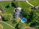 An aerial view showcasing a home with a pool, patio, and a meticulously landscaped backyard at 1700 White Pond Ln, Waxhaw, NC 28173