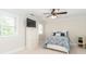 Comfortable bedroom with television and two windows with neutral walls and carpet at 1700 White Pond Ln, Waxhaw, NC 28173