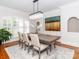 Bright dining room featuring a modern chandelier, large windows, and stylish decor at 1700 White Pond Ln, Waxhaw, NC 28173