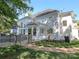Rear exterior view of the home with a brick patio and landscaped yard at 1700 White Pond Ln, Waxhaw, NC 28173