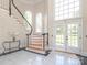 Grand foyer features marble floors, elegant staircase, and abundant natural light at 1700 White Pond Ln, Waxhaw, NC 28173